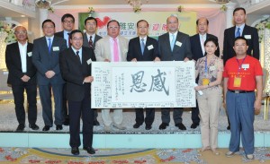 交流團領隊王軍(前排右一)送給香港朋友們一副「感恩」的字畫，畫上有百多名雅安學童的簽名，經民聯主席梁君彥代表接受。